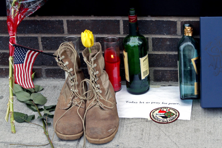 In the aftermath of the death of Osama bin Laden, a tribute including a pair of military boots, is left outside Firehouse 343 at the World Trade Center construction site in New York.
