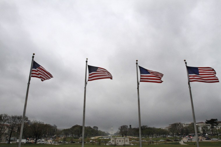 Flags blow in the breeze as storm clouds roll in over the National Mall near the Washington Monument toward the Capitol ... a government shutdown is still looming.