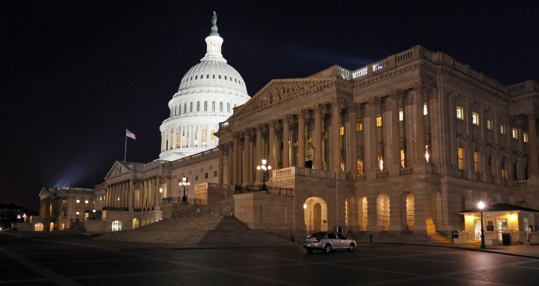 The U.S. Capitol is illuminated at night as Congress continues to work to avert a government shutdown on Capitol Hill.