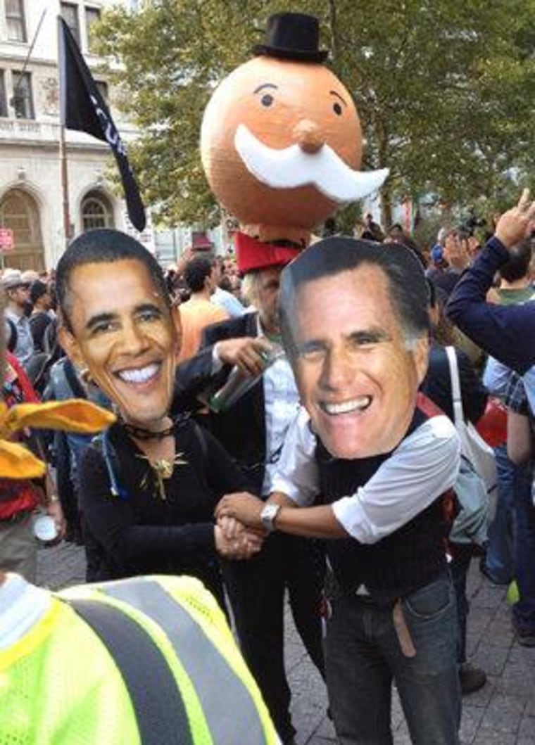 Two Occupy protesters don Obama and Romney masks in New York City during the one-year anniversary protest on September 17, 2012.