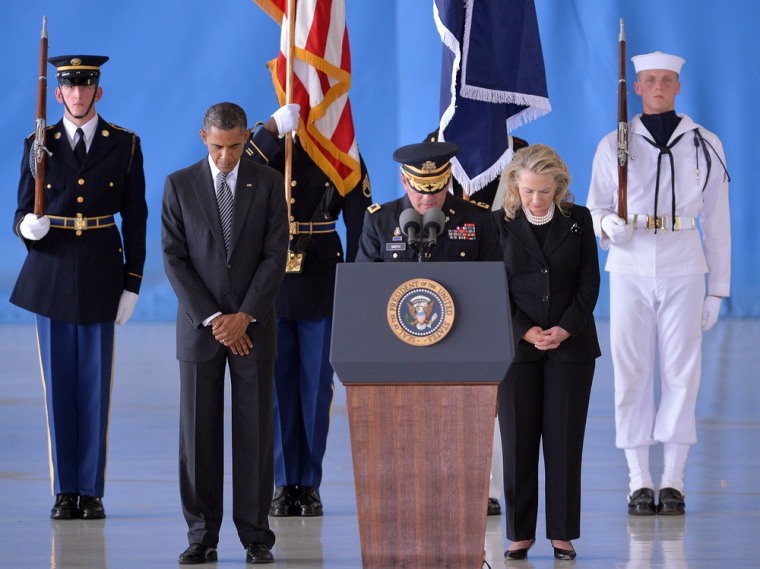 President Barack Obama and State Secretary Hillary Clinton bow during the transfer of remains ceremony for the four Americans killed in an attack this week in Benghazi, Libya, at the Andrews Air Force Base in Maryland, Sept. 14.