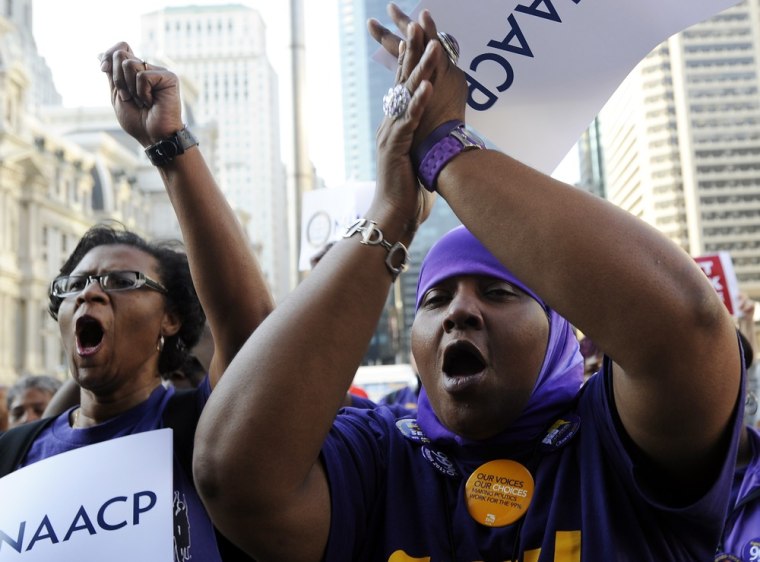 Jacqueline Coles, left, and Karmella Sams cheer during the NAACP voter ID rally Thursday, September 13, 2012, in Philadelphia.