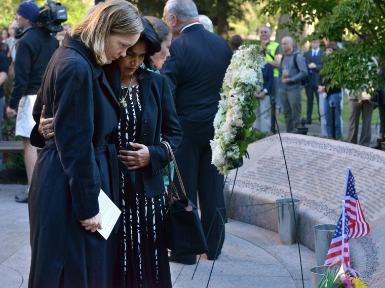 Katie Pakenham, left, whose brother was killed in the attacks on the World Trade Center in 2001, and Teresa Methai, whose husband Joseph Methai was also killed, embrace each other as they stand in front of the 9/11 memorial on Boston Public Garden,...