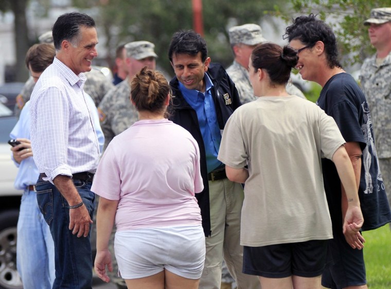 Republican presidential candidate Mitt Romney left, and Louisiana Gov. Bobby Jindal, center, greet residents displaced by Isaac in Lafitte, La., Friday, Aug. 31, 2012.