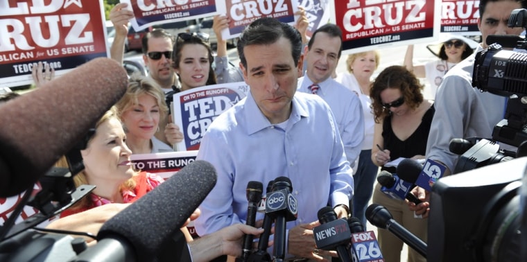 During the Republican primary campaign, Ted Cruz, center, is surrounded by supporters and media at a voting precinct Tuesday, July 31, 2012, in Houston.