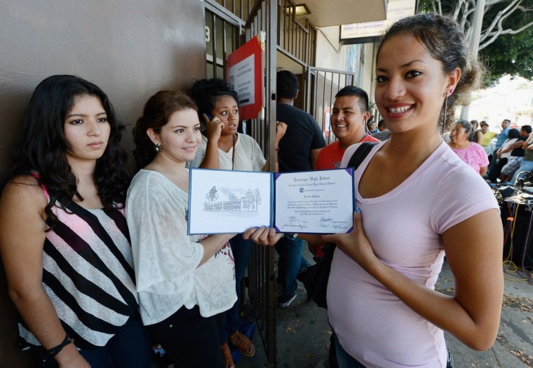 Brenda Robles, 20, (right) holds her high school diploma as she waits in line with her friends at at the Coalition for Humane Immigrant Rights of Los Angeles offices to apply for deportation reprieve on August 15, 2012 in Los Angeles, California.