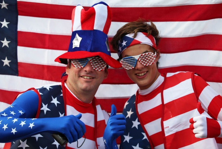 U.S. fans pose with their national flag outside Olympic Stadium on July 27.