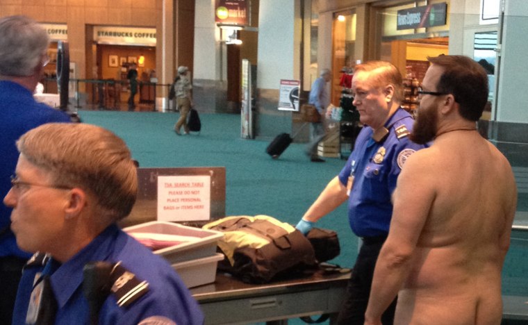 In this Tuesday, April 17, photo taken at Portland International Airport, John E. Brennan stands naked after he stripped down while going through a security screening area, as a protest against airport security procedures. The incident report said...