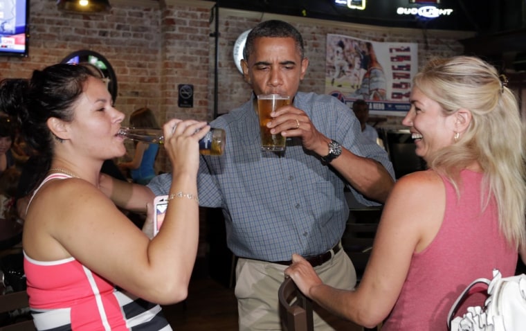 President Obama enjoys a beer with Jennifer Klanac (L) and Suzanne Woods (R) at Ziggy's Pub in Amherst, Ohio July 5.