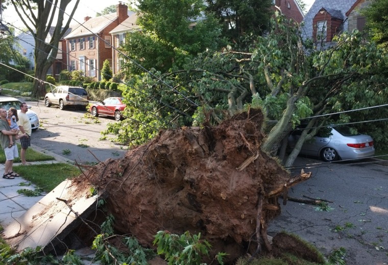 An uprooted tree lies across a street in the American University neighborhood of Washington, D.C., on June 30. The fast-moving storms produced hurricane-force winds in excess of 80mph.