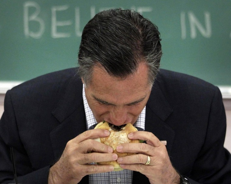Republican presidential candidate Gov. Mitt Romney eats a burger before a roundtable discussion with students at Otterbein University in Westerville, Ohio, April 27.