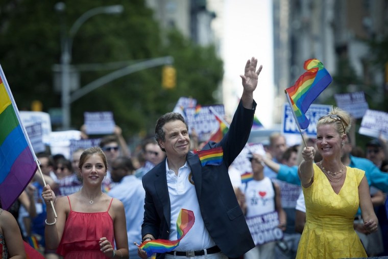 New York State Gov. Andrew Cuomo (L) and his girlfriend Sandra Lee march in the gay pride parade in New York, June 24, 2012.