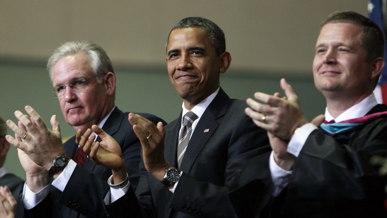 President Barack Obama with Missouri Gov. Jay Nixon, left, and Superintendent C.J. Huff, right, applaud the Class of 2012 at the Joplin High School commencement ceremony on Monday.