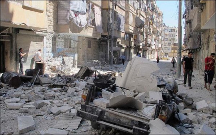 A damaged vehicle is seen after shelling by forces loyal to President Bashar al-Assad in Aleppo's district of Bustan Al Qasr August 7, 2012.