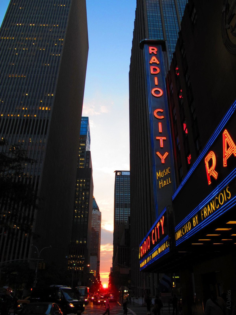 Clouds part for Manhattanhenge pilgrims