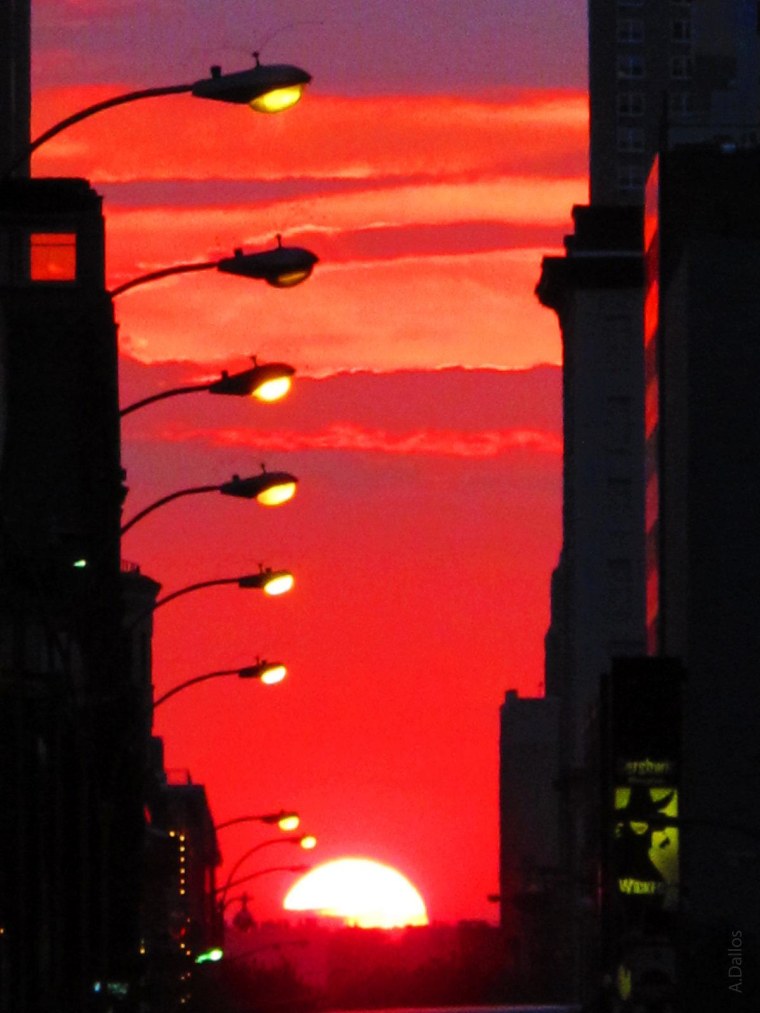 Clouds part for Manhattanhenge pilgrims