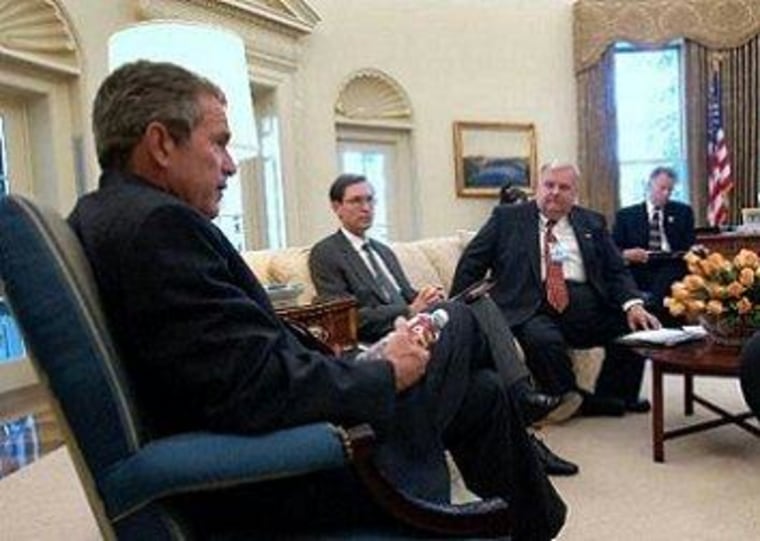 Glenn Hubbard, sitting to the right of George W. Bush in the Oval Office.