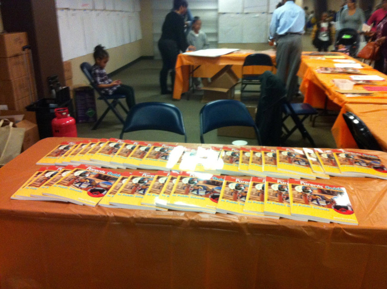 A table full of Aesha Rasheed's Parent's Guides, published by her New Orleans Parent Organizing Network.