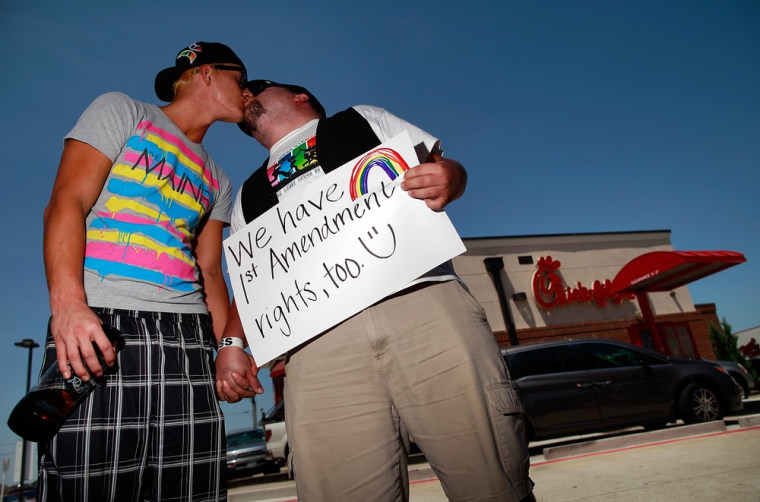 A same-sex couple in Dallas, Tx. share a kiss outside a Chick-fil-A in protest of the restaurant's stance on same-sex marriage.