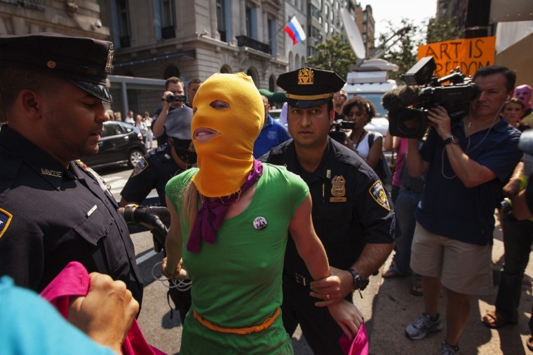 New York Police Department officers arrest a woman demonstrating in solidarity with the Russian punk band Pussy Riot in front of the Russian Consulate in New York August 17, 2012.