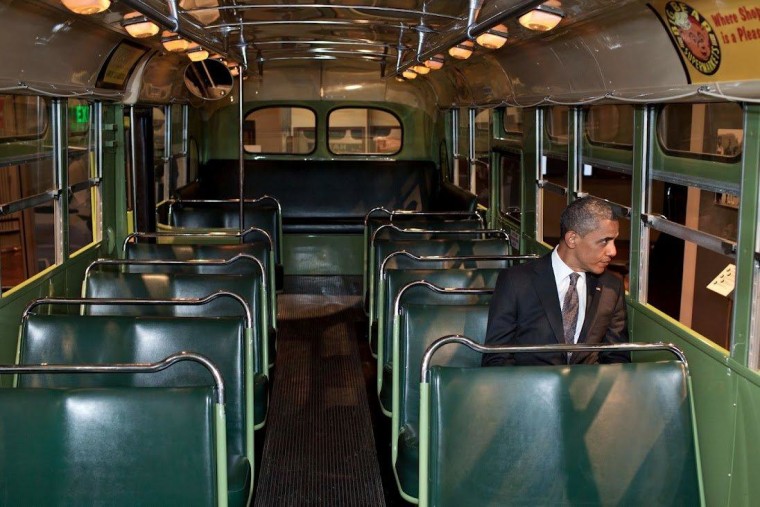 President Obama sits at the front of the bus