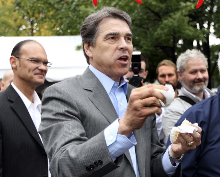 Republican presidential candidate, Texas Gov. Rick Perry reacts after taking a bite of chili during a campaign stop a the Chili Festival Saturday, Oct. 1, 2011, in Manchester, N.H.