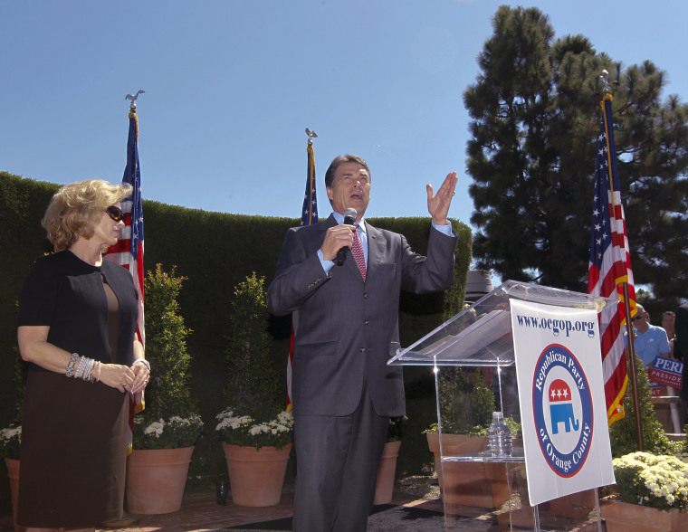 Republican presidential candidate Texas Gov. Rick Perry, right, speaks as his wife Anita looks on during a Republican Party of Orange County rally at Roger's Gardens in Newport Beach, Calif., Thursday, Sept. 8, 2011.