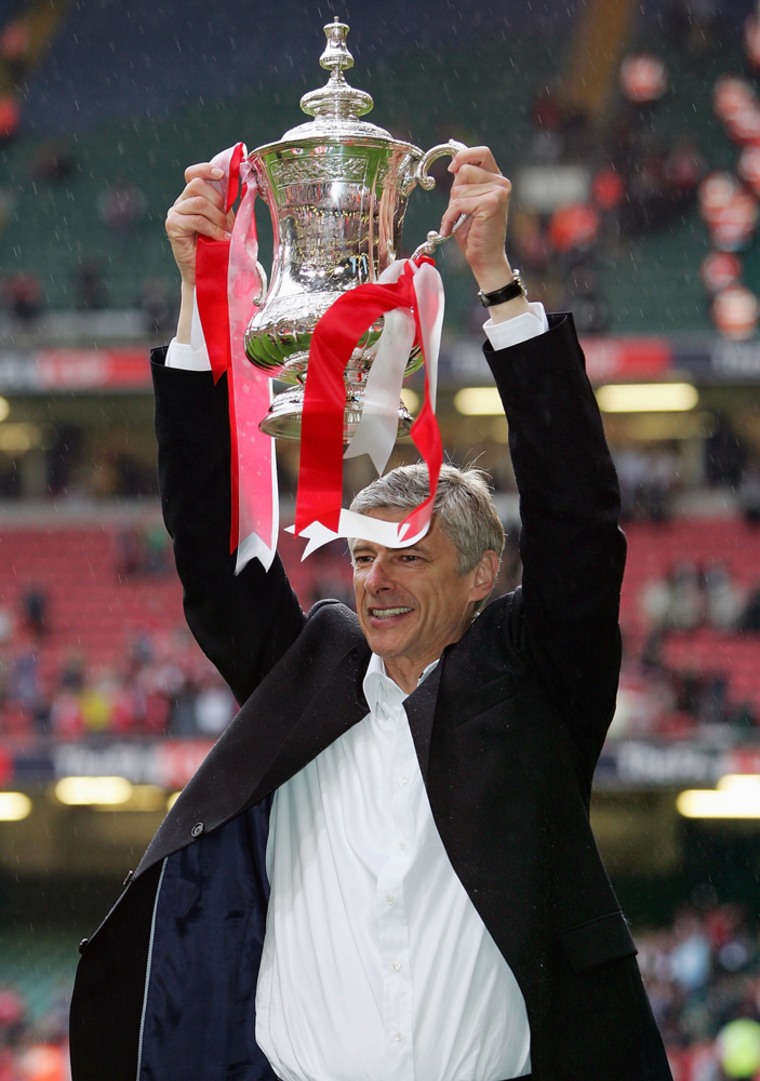 CARDIFF, UNITED KINGDOM - MAY 21: Arsenal Manager, Arsene Wenger holds aloft the trophy after winning the FA Cup Final between Arsenal and Manchester United 5-4 on penalty's at The Millennium Stadium on May 21, 2005 in Cardiff, Wales.