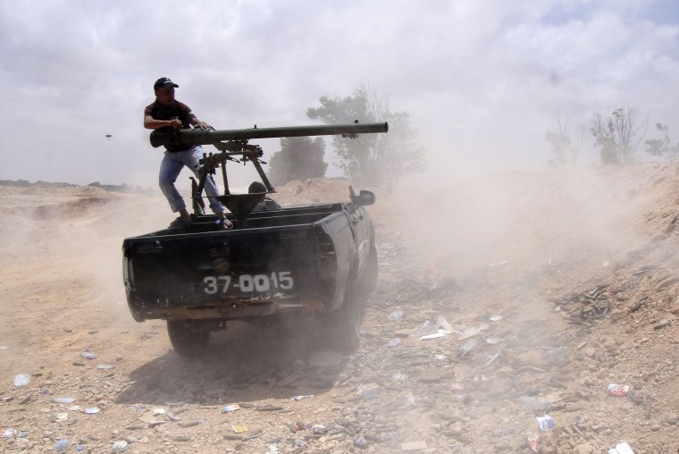 A Libyan rebel fires a rocket towards pro-Moammar Khaddafy forces on the front line of Dafniya in Misrata, Libya, Tuesday, June 21, 2011. Rockets fired by Libyan government troops have been hitting closer to Misrata this week. On Monday, a rocket...