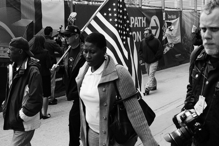 A man carries a flag at the WTC.