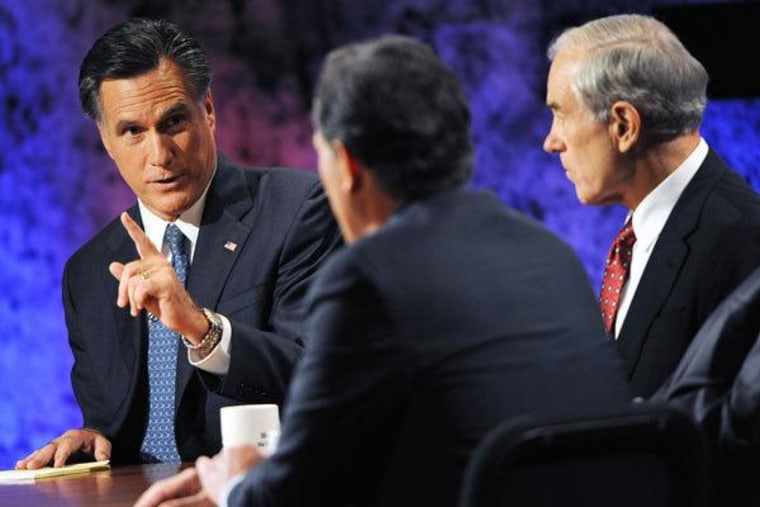Mitt Romney facing off with former rivals Rick Santorum and Ron Paul during a 2011 Republican debate in Hanover, New Hampshire.