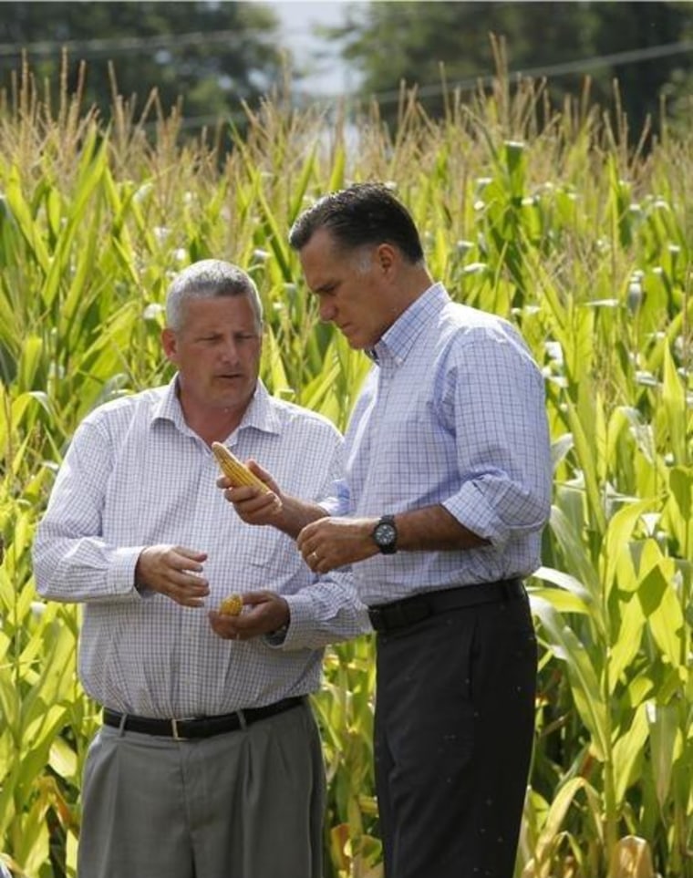 Republican presidential candidate, former Massachusetts Gov. Mitt Romney talks with Iowa Agriculture Secretary Bill Northey , center, and farm owner Lemar Koethe in Des Moines, Iowa, Wednesday, Aug. 8, 2012.