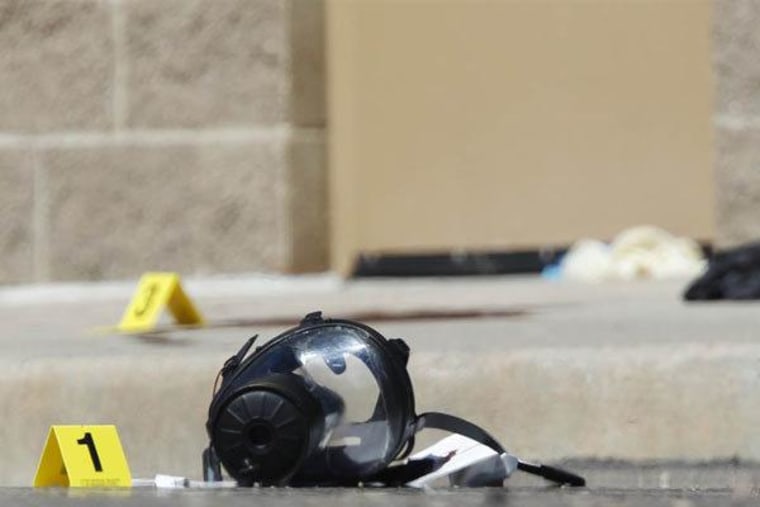 A gas mask marked as evidence sits on the sidewalk outside the Century 16 movie theater.