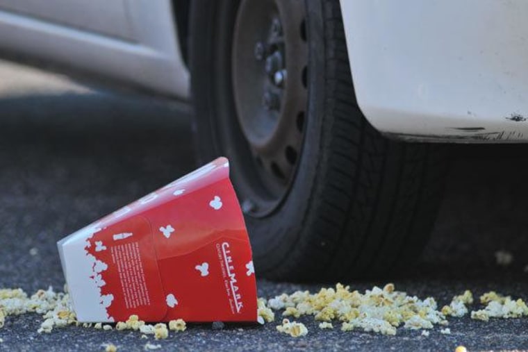 A popcorn box lies on the ground outside the movie theater in Aurora, Colorado.