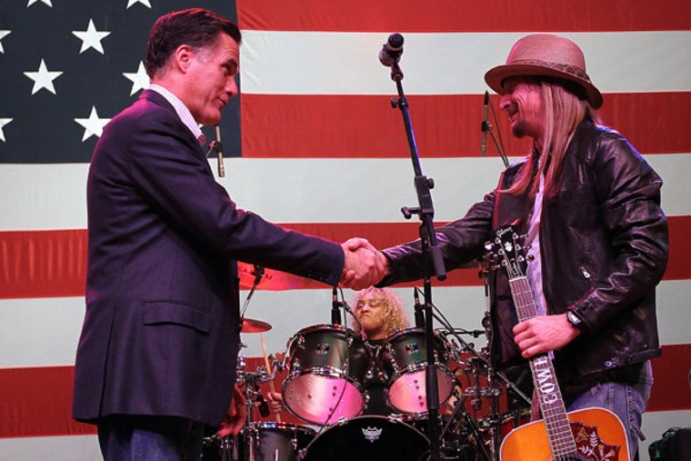 Mitt Romney greeting musician Kid Rock during a campaign rally in Royal Oak, Michigan on Monday.