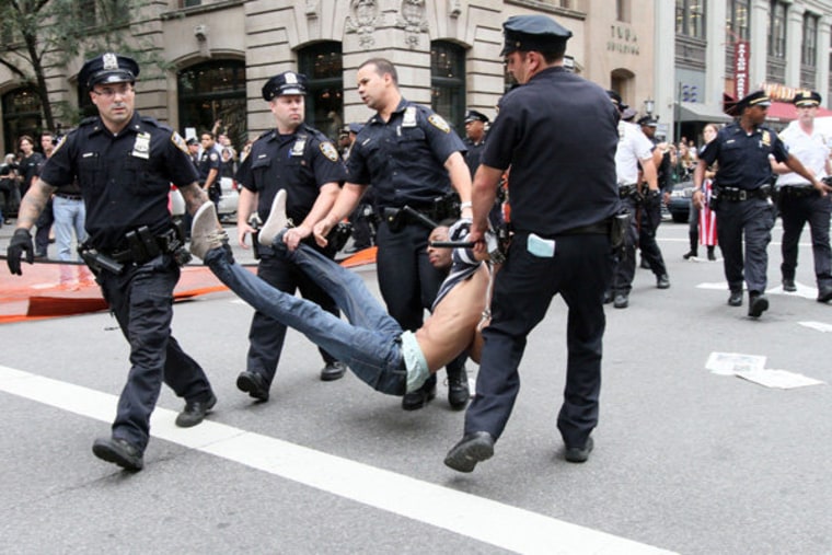 A man being carried away by New York City police officers on Saturday, September 24.