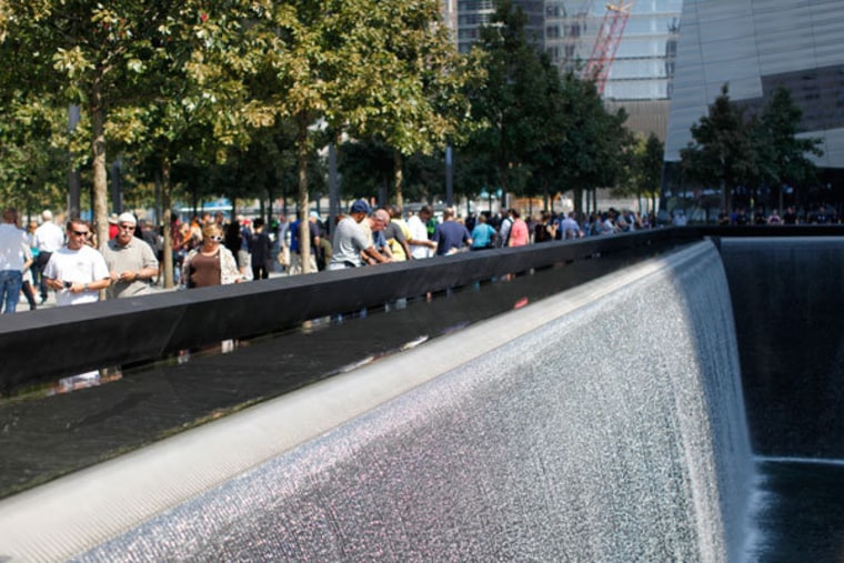 Visitors standing near one of the reflecting pools in New York on Monday.