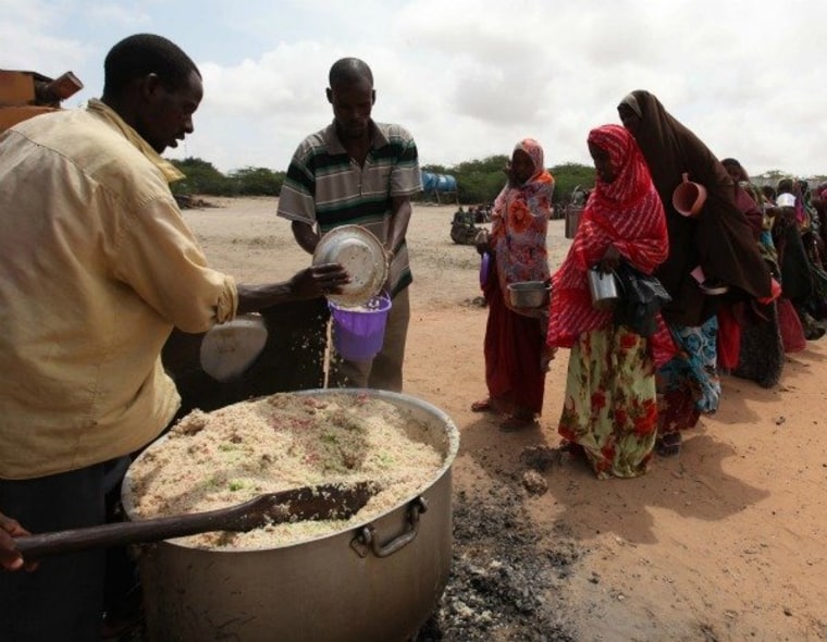Displaced Somali people line up for food south of Mogadishu on Sept. 5, 2011