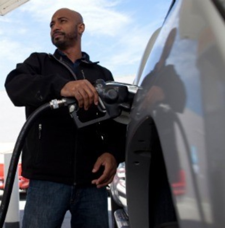 A man fills his tank in San Francisco. Regular unleaded gas is averaging $4.22 a gallon in California.