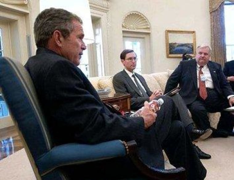 Glenn Hubbard, sitting to the right of George W. Bush in the Oval Office.