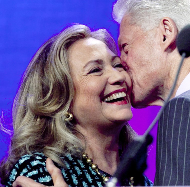 CROPPED VERSION OF NYML101 -- United States Secretary of State Hillary Rodham Clinton is kissed by her husband, former U.S. President Bill Clinton, as he welcomes her to  the podium at the Clinton Global Initiative, Monday, Sept. 24, 2012 in New York. ...