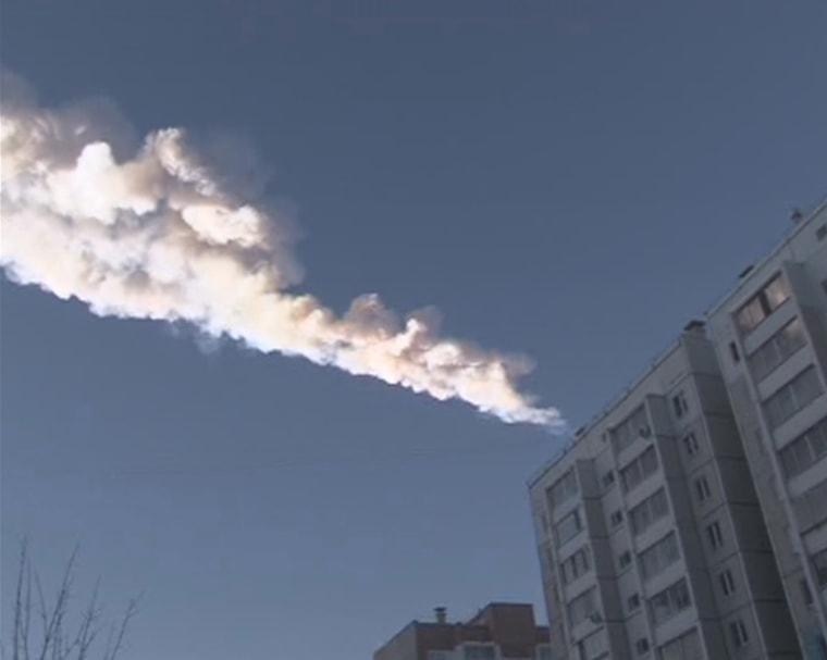 The trail of a falling object is seen above a residential apartment block in the Urals city of Chelyabinsk, in this still image taken from video shot on February 15, 2013. A powerful blast rocked the Russian region of the Urals early on Friday with...