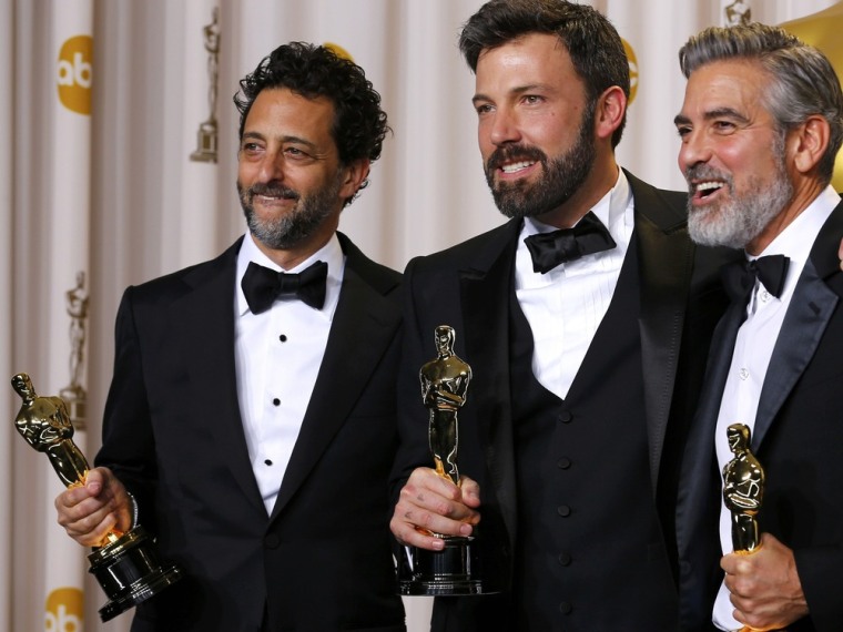The producers of \"Argo, the winner for best picture, Grant Heslov, Ben Afleck (C) and George Clooney (R), pose with their awards backstage at the 85th Academy Awards in Hollywood, California, February 24, 2013.    REUTERS/Mike Blake (UNITED STATES  -...