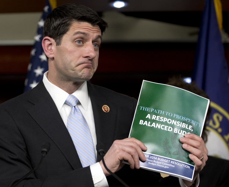 House Budget Committee Chairman Rep. Paul Ryan, R-Wis., holds up a copy of the 2014 Budget Resolution as he speaks during a news conference on Capitol Hill in Washington, Tuesday, March 12, 2013. (AP Photo/Carolyn Kaster)