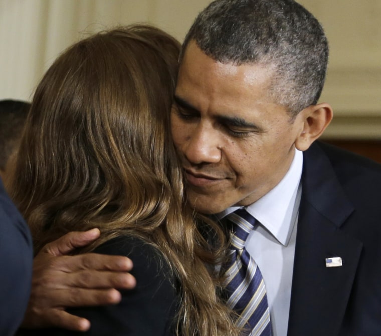President Barack Obama hugs Katerina Rodgaard, a Maryland dance instructor who knew one of the victims of the Virginia Tech shootings, after she introduced him in the East Room of the White House in Washington, Thursday, March 28, 2013, where the...