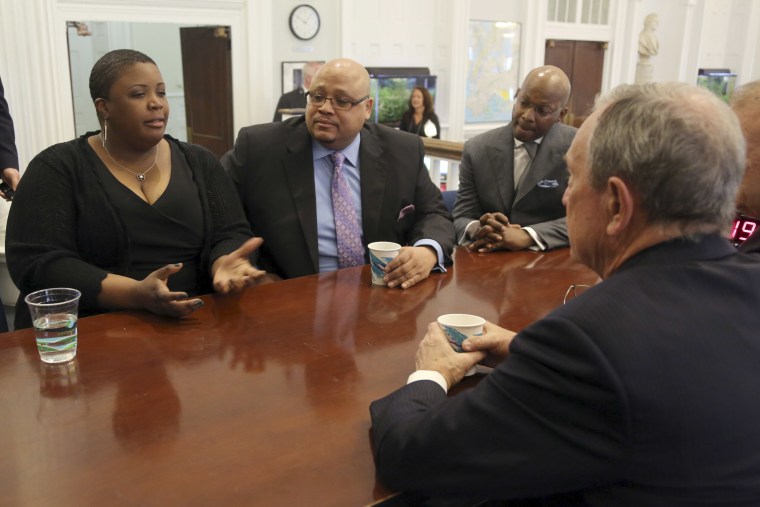 New York City Mayor Michael Bloomberg, foreground, meets with Cleopatra Cowley-Pendleton, left, and Nathaniel A. Pendleton Sr., center, and Van Vincent, Thursday, April 4, 2013 at City Hall in New York. The Pendletons are the parents of Hadiya...