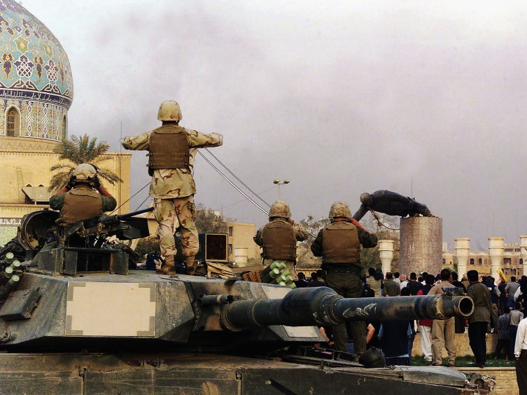 File Photo: U.S marines and Iraqis are seen on April 9, 2003, as the statue of Iraqi dictator Saddam Hussein is toppled at al-Fardous square in Baghdad, Iraq. (Photo by Wathiq Khuzaie /Getty Images, File)