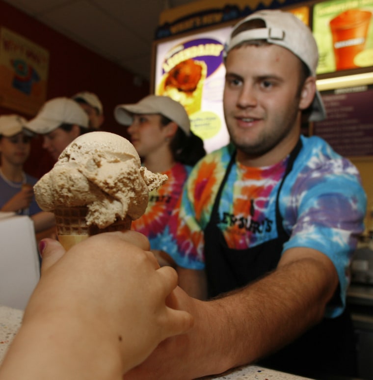 Aleck Woodmaster serves up a free ice cream cone at the Ben &amp; Jerry's shop in Montpelier, Vt., Tuesday, April 25, 2006. The ice cream maker held its annual free cone day around the world and expects to give away more than a million cones. (AP Photo...