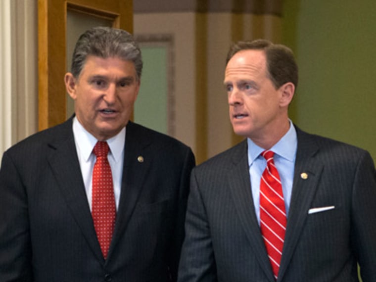 Senators Joe Manchin and Patrick Toomey in Washington, D.C. on April 10, 2013. (Photo by J. Scott Applewhite/AP)