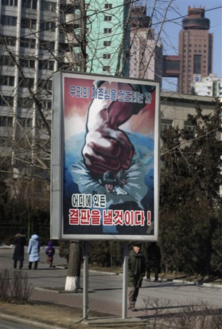 A billboard showing a fist crushing an American soldier reads \"We will settle the score with those who hurt our pride wherever they are\" in Pyongyang, North Korea, 2008. (AP Photo/David Guttenfelder)